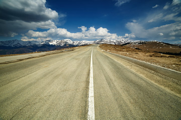 Empty highway to the mountains