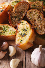 Slices toasted bread with herbs and garlic. Vertical, rustic

