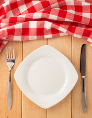 kitchen utensils and cloth napkin on wood