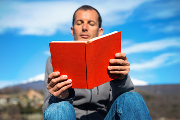 man reading red book
