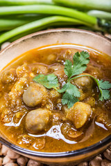 indian spicy chana masala with raw chickpeas and green chilli to