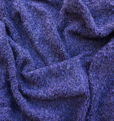 Fototapeta na wymiar purple fuzzy soft knit fabric with folds