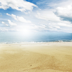 Fototapeta na wymiar Beach sand, sea and sky