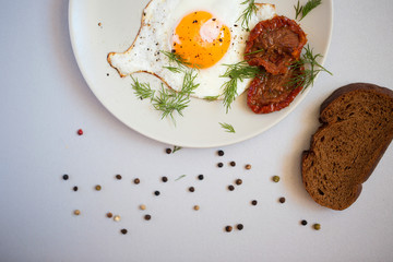 Fried egg on a plate and bread.
