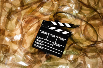 Clapper board on 35mm unrolled movie filmstrip blank frames carp