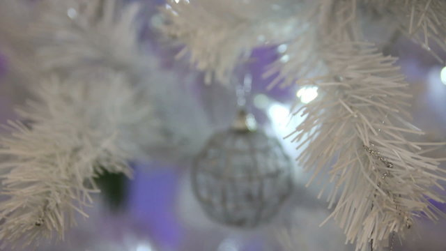 ball on a white Christmas tree
