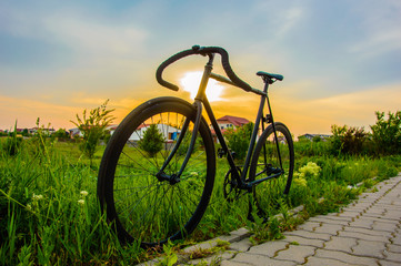 Naklejka na ściany i meble Bicycle at sunset