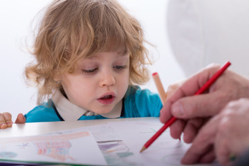 Child and parent drawing together