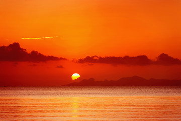 Beautiful close up orange seascape sunset with cloudy sky 