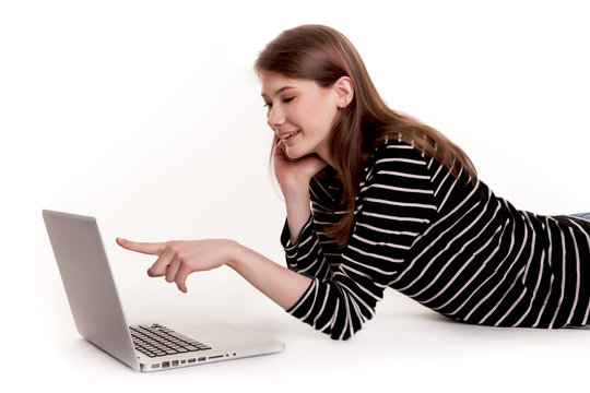 Young Smiling Woman showing PC Screen on Floor Stock Image