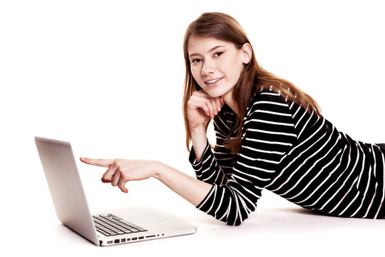 Young Smiling Woman showing PC Screen on Floor Stock Image