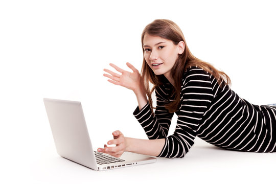 Young Happy Woman lying on floor with Laptop Stock Image