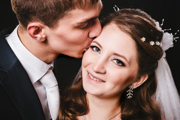Bride and groom kissing, hugging. wedding photo taken in the