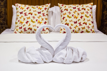 Two swans heart shaped made from towels.