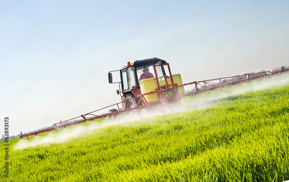 Poster tractor spraying wheat field