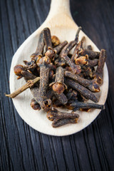 pile cloves on wooden spoon