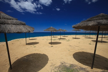 beautiful of palm leaves umbrellas on the beach
