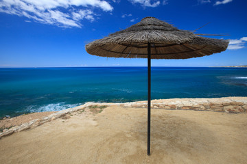 beautiful parasol made of palm leaves close up on the beach
