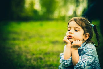 Happy little pretty girl outdoor in the park