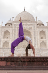 Young female practising yoga Bridge pose 
