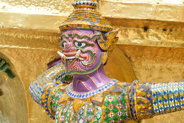 The Golden Pagoda and Yak statue at the phra kaew