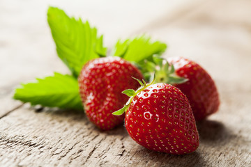 Delicious fresh strawberries on wooden background