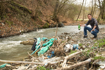 Man beside a polluted rivers