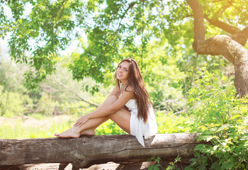 Beautiful young girl on the nature in sunny summer day