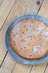 A delicious carrot cake on a plate lying on gray. 