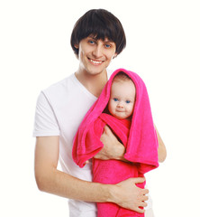 Portrait of young father holding on hands wet baby in towel