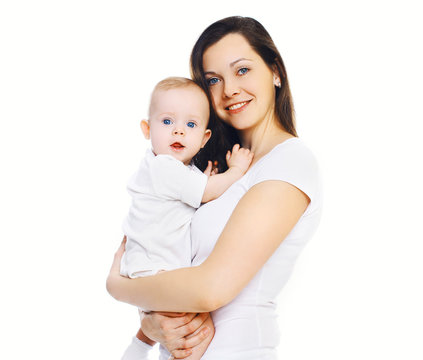 Portrait of happy young mother holding on hands her baby