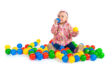Fototapeta na wymiar Baby playing with colored balls
