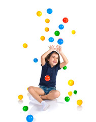 Fototapeta premium Girl playing while raining colored balls