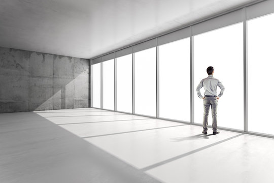 Business Man Standing Inside An Office Building Looking Outside