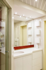 Modern bathroom with mirrors and cab