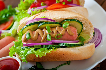 Fototapeta premium Hotdog with ketchup, mustard, lettuce and vegetables 
