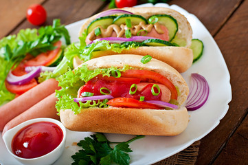 Hotdog with ketchup, mustard, lettuce and vegetables 