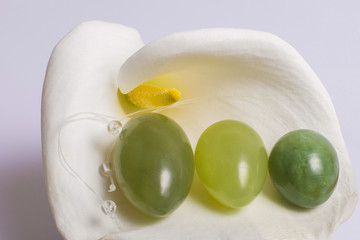 Jade eggs for development intimate muscles lie on white flower