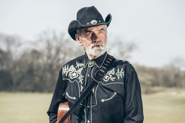 Thoughtful senior Country and Western musician