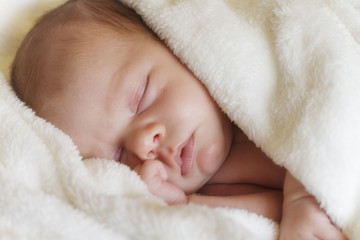 New born baby sleeping with blanket