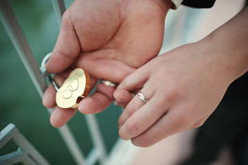 Fototapeta premium hands wedding couple with lock and rings