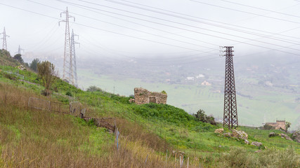 Stone hovel and eletricy pylons