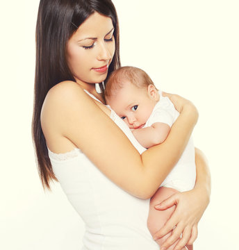 Portrait of young loving mother hugging infant