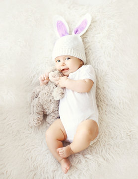 Soft photo of sweet cute baby in knitted hat with a rabbit ears