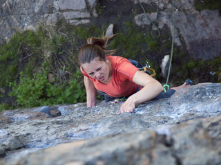 Strong girl climbs the mountain.