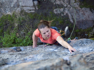 Strong girl climbs the mountain.