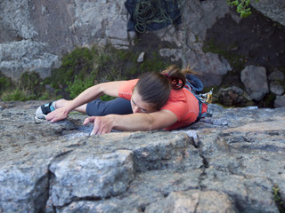 A young girl climbs mountain.