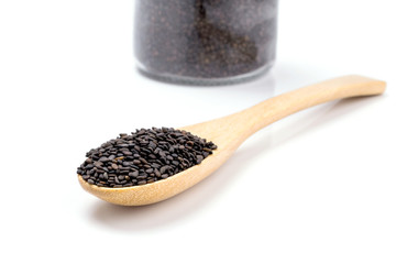 Heap of black sesame on wooden spoon