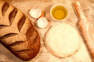 homemade baking. Fresh dough for pastry, kitchen rolling pin, bread, broken eggs on a chopping Board