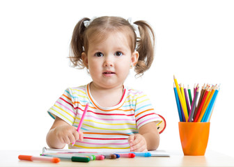 child little girl draws with pencils